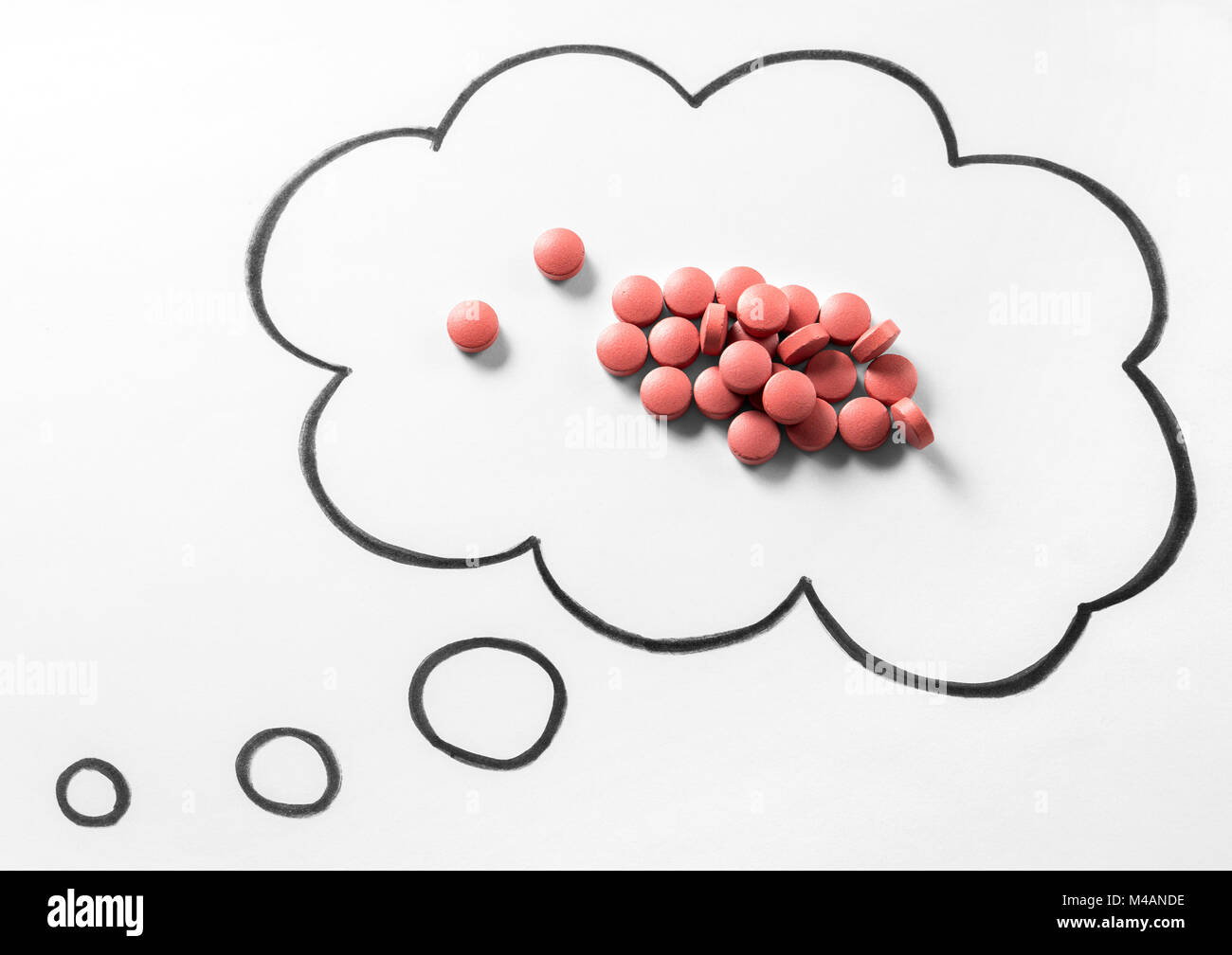 Drug addiction or problem or wondering right medication concept. Pile of pills in thinking speech bubble and thought cloud hand drawn on paper. Stock Photo