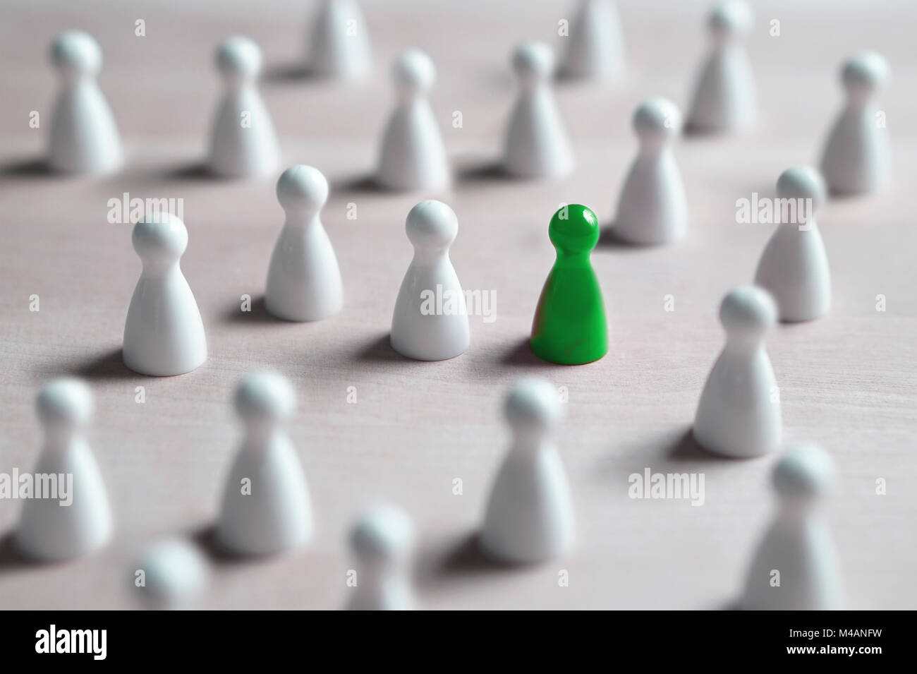 One different board game pawn. Individuality, independence, leadership and uniqueness concept. Stand out from the crowd. Think outside the box. Stock Photo