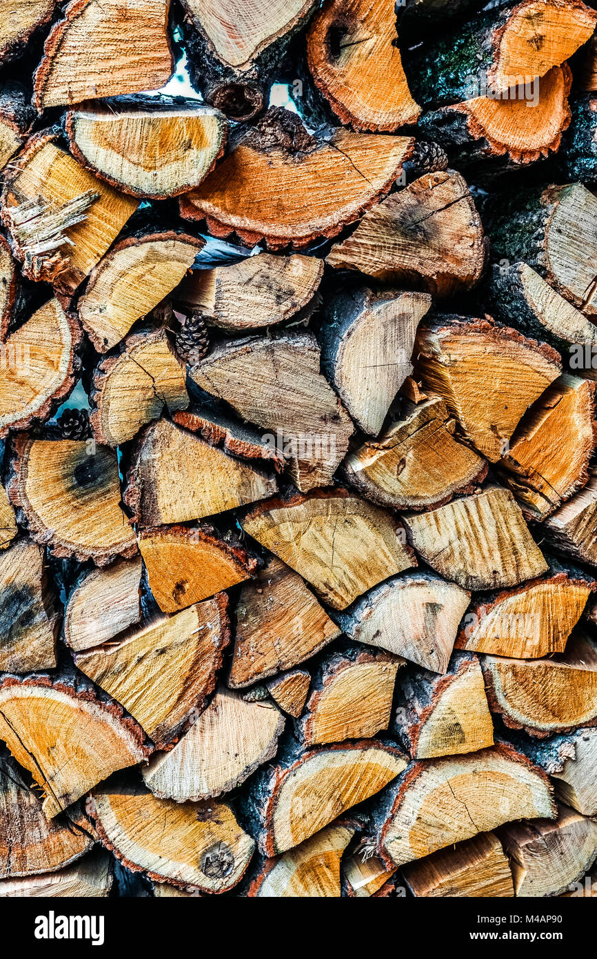 Big wall of stacked wood logs showing natural discoloration Stock Photo