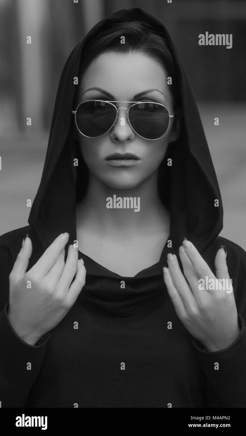 Fashion cool girl in sunglasses in urban background Stock Photo