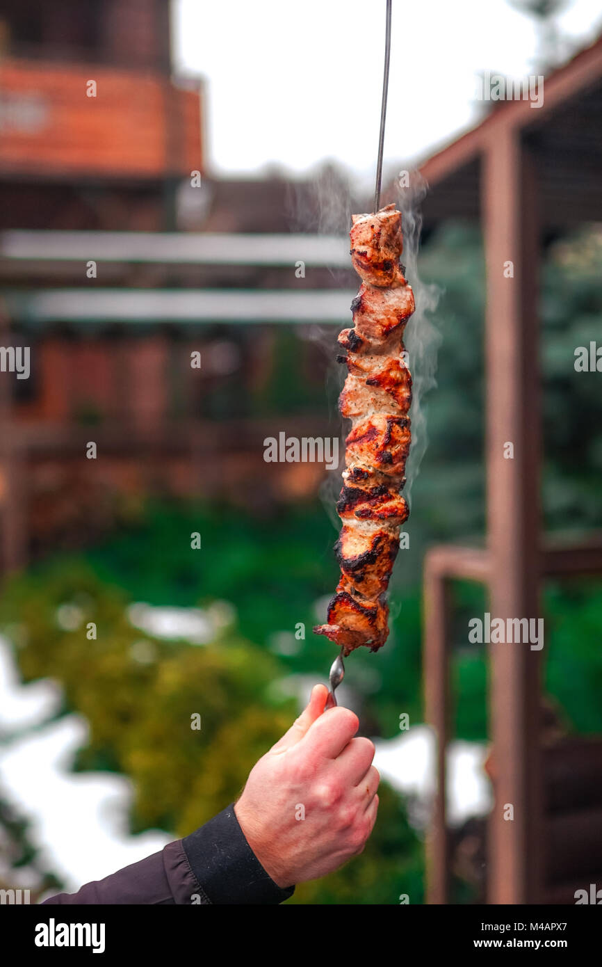 Grilling marinated shashlik on a grill. Shashlik is a form of Shish kebab  popular in Eastern, Central Europe and other places. Shashlyk meaning skewer  Stock Photo - Alamy