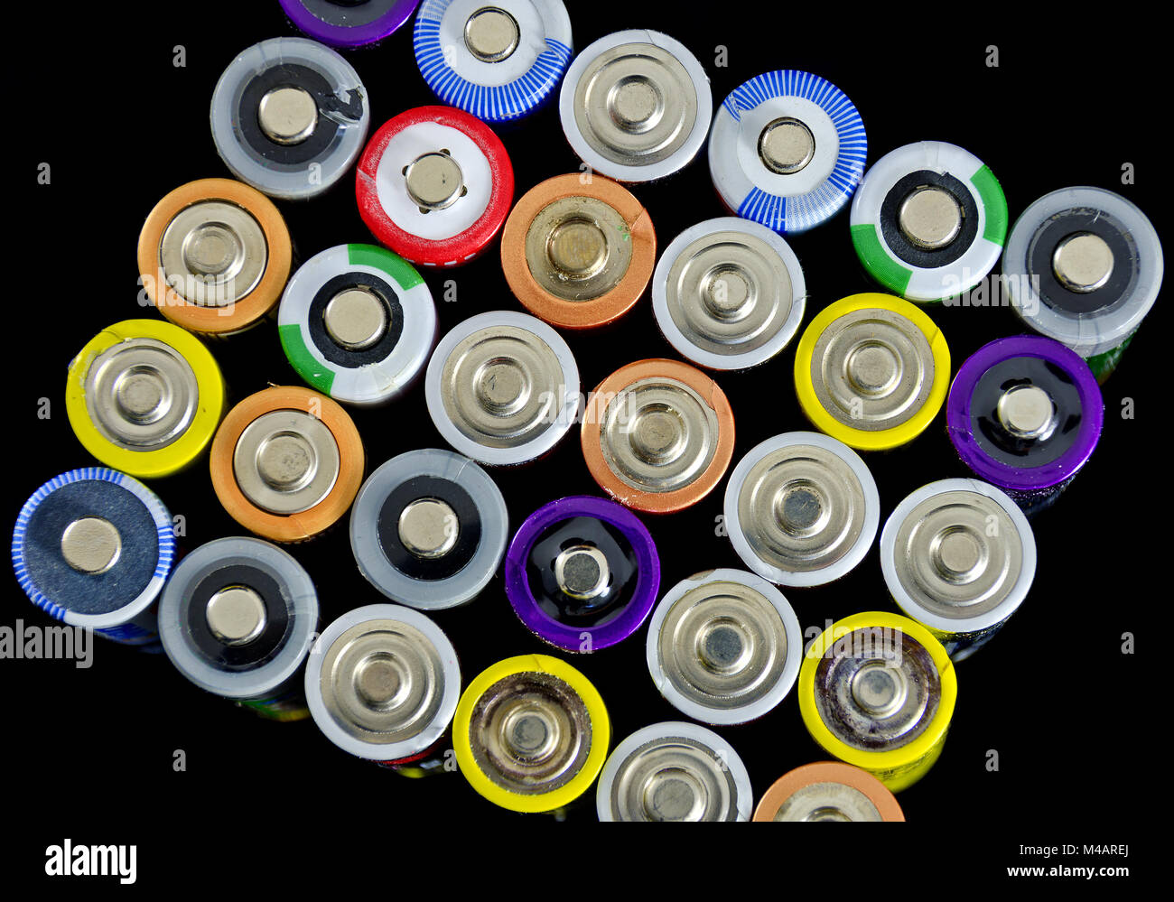 positive poles of used batteries and rechargeable cells Stock Photo
