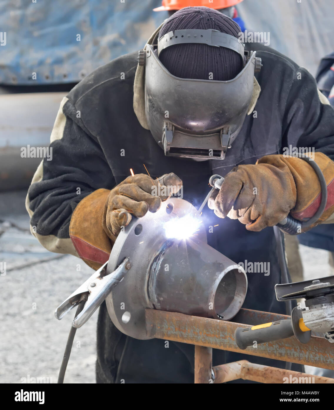 Manual arc welding conical transition with a skirted flange Stock Photo