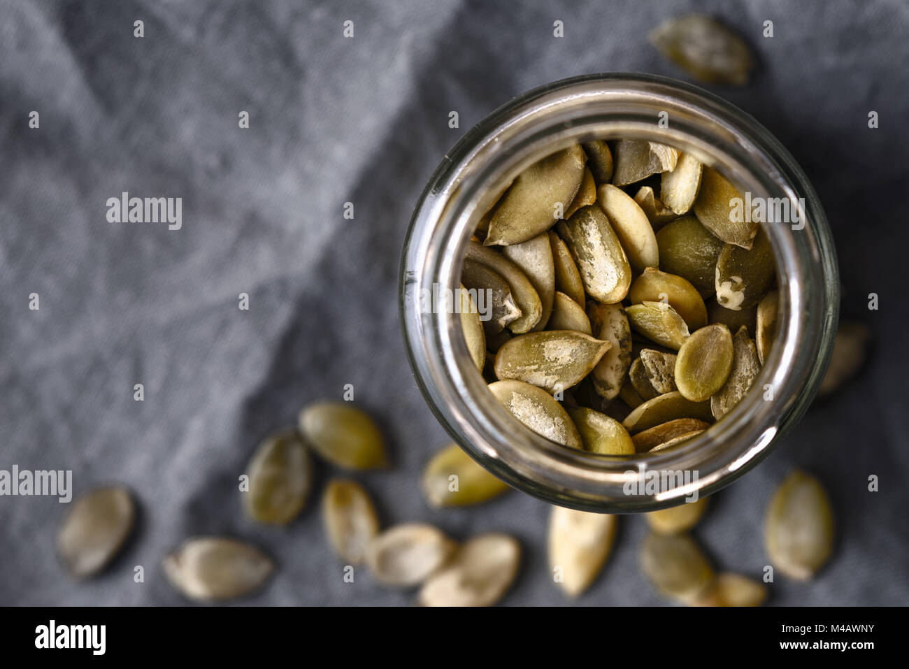 Pumpkin seeds in the glass jar cloth-up Stock Photo