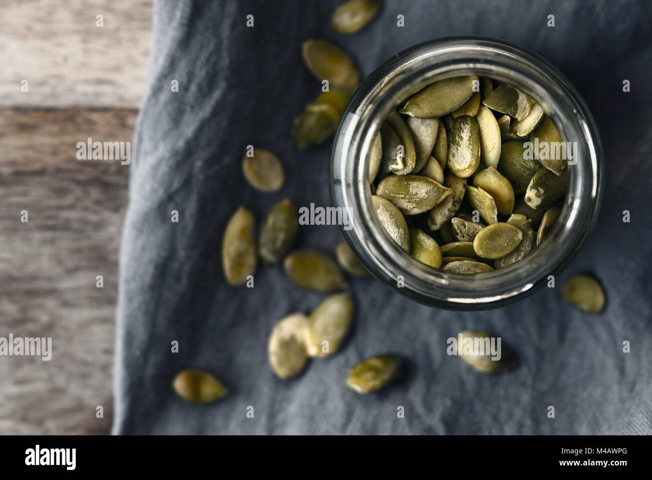 Pumpkin seeds in the glass jar top view Stock Photo