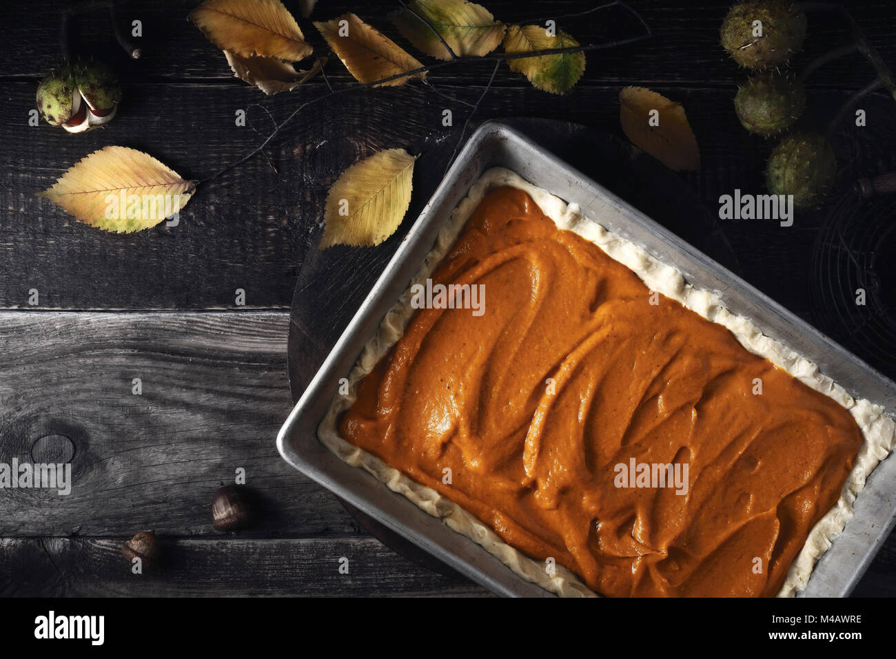 Raw pumpkin pie  on the wooden table top view Stock Photo