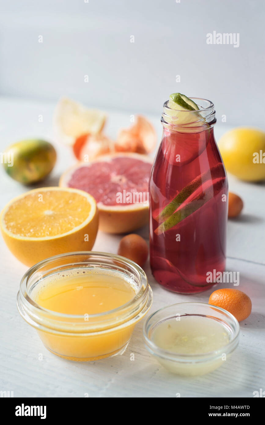 Detox citrus cocktail on the white wooden table vertical Stock Photo