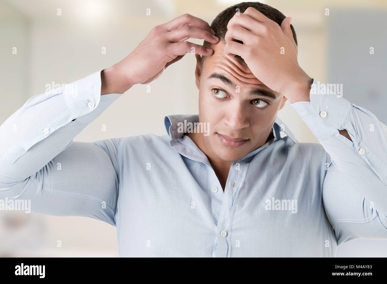 Man Checking Hairline Stock Photo