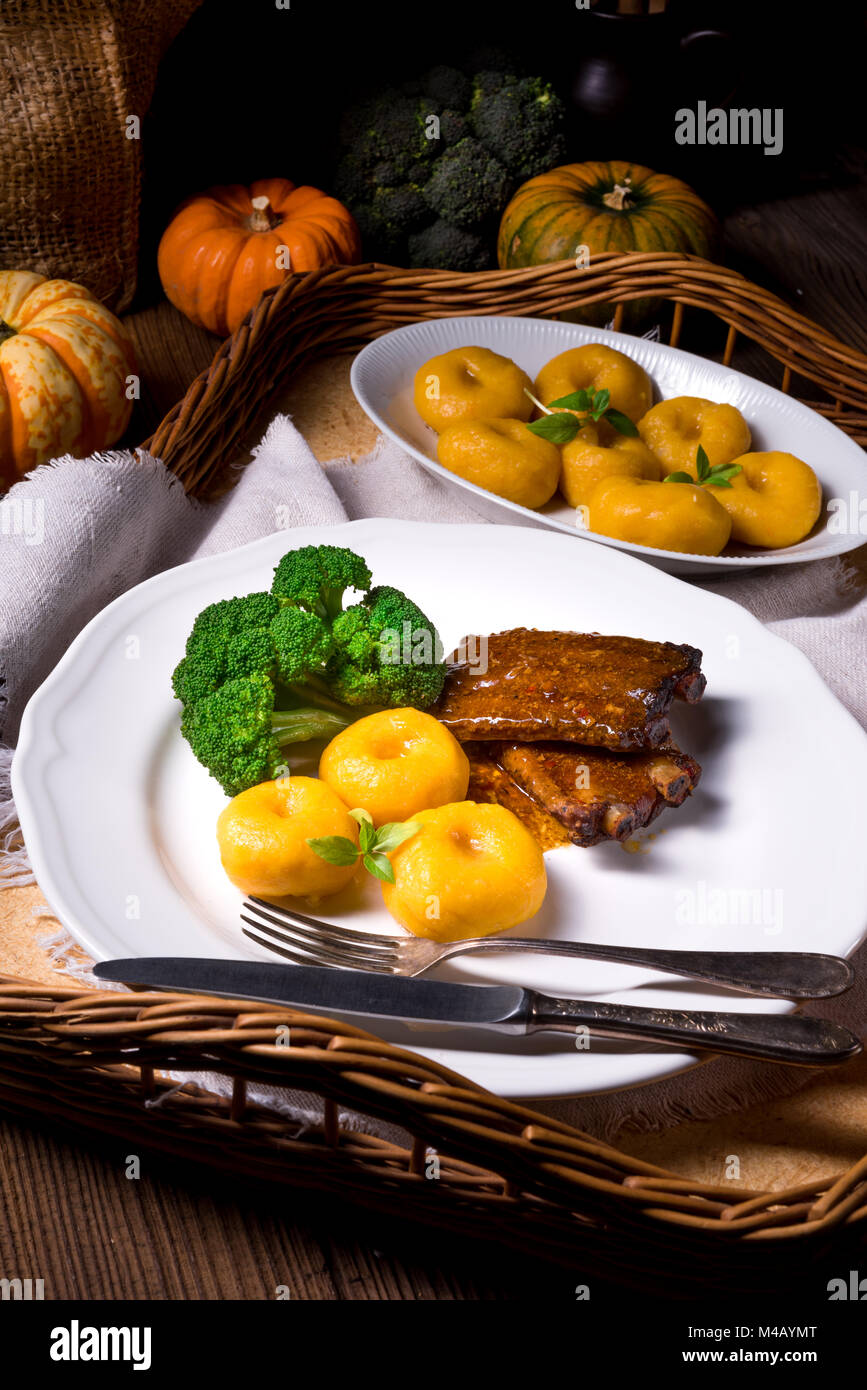 dumplings with pumpkin puree and grilled  ribs Stock Photo