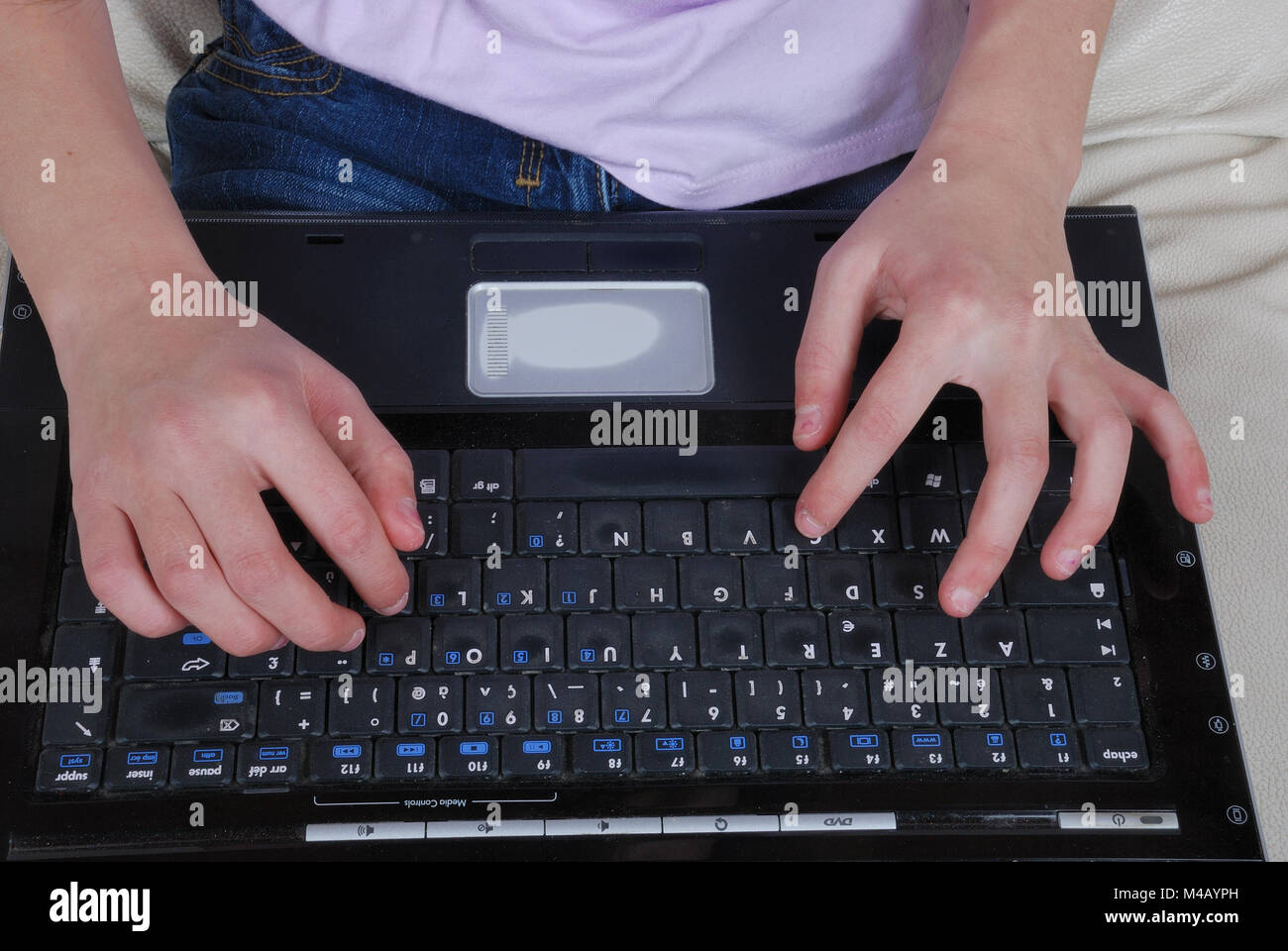 Girl sitting on the sofa and using laptop Stock Photo - Alamy