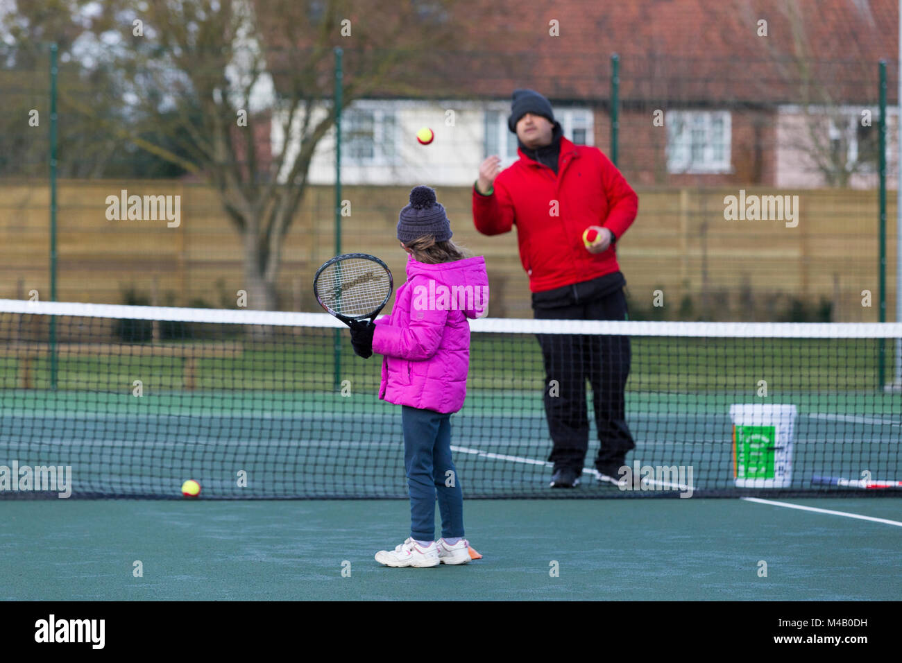 Children's tennis coaching session / lesson taking place on a fullsize