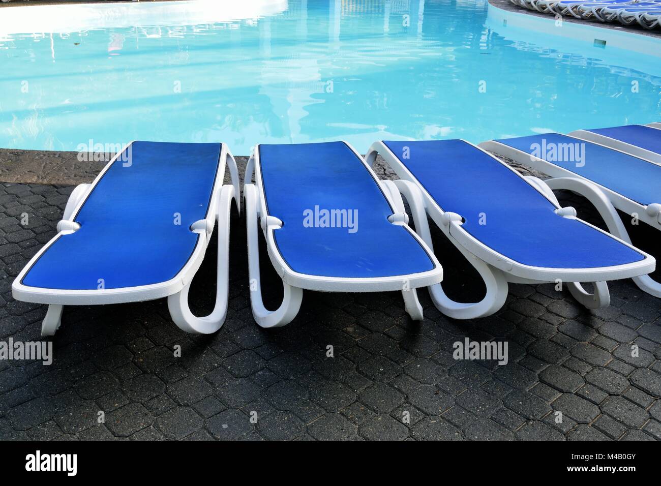 Sun beds by the pool Stock Photo Alamy