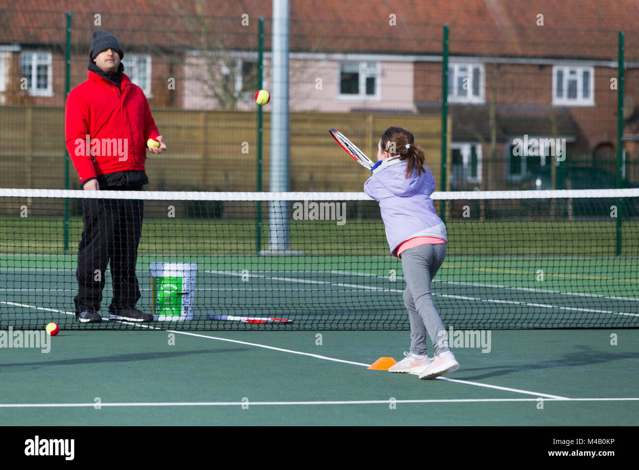 Children's tennis coaching session / lesson taking place on a fullsize