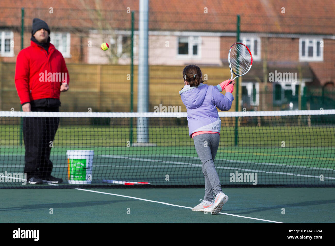 Children's tennis coaching session / lesson taking place on a fullsize
