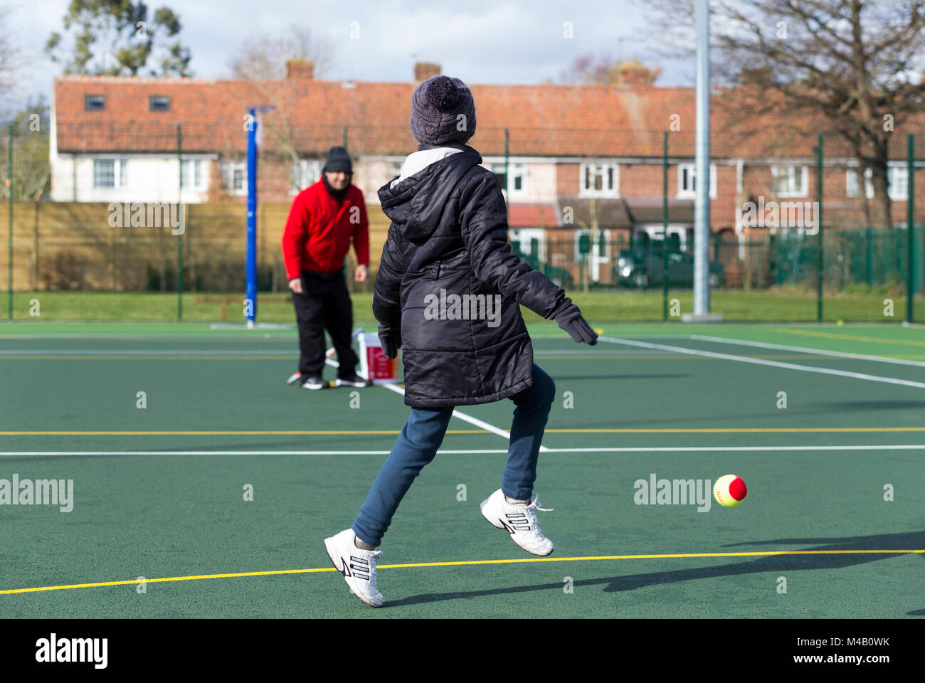 Children's tennis coaching session / lesson taking place on a fullsize