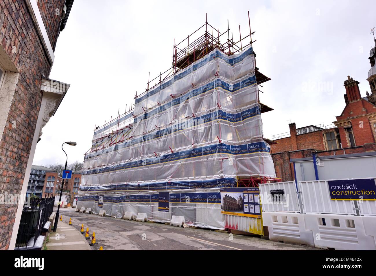 Protective plastic sheeting on construction scaffolding York England UK Stock Photo