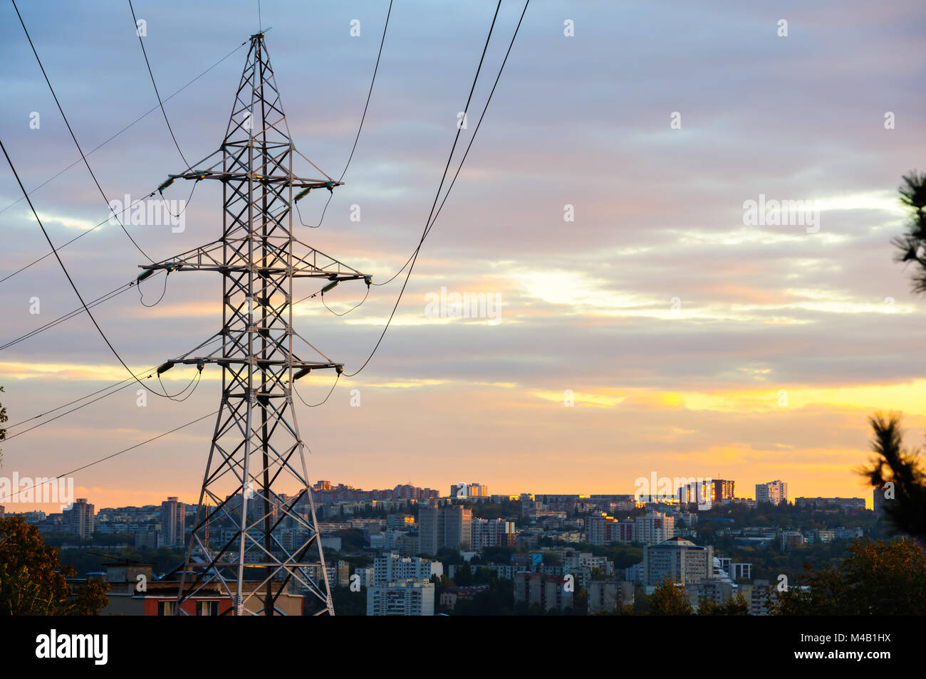 Electricity pylons and power lines silhouettes at a cloudy sunset Stock ...