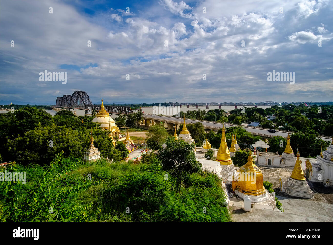 Some of many golden Pagodas on Sagaing Hill, the Yadanabon Bridge crossing the Irrawaddy river in the distance Stock Photo