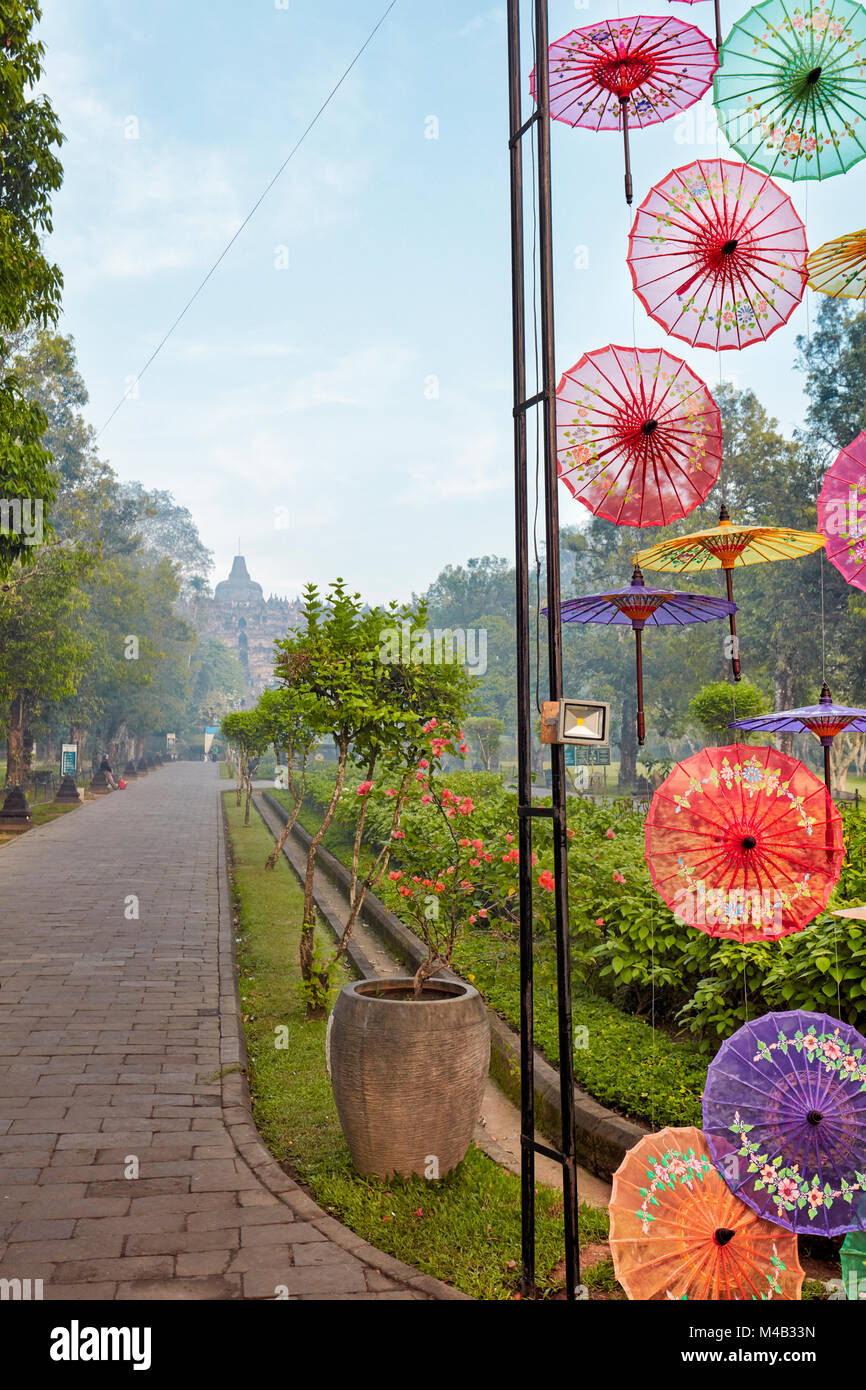Colorful installation of umbrellas on the way to the Borobudur Buddhist Temple. Magelang Regency, Java, Indonesia. Stock Photo