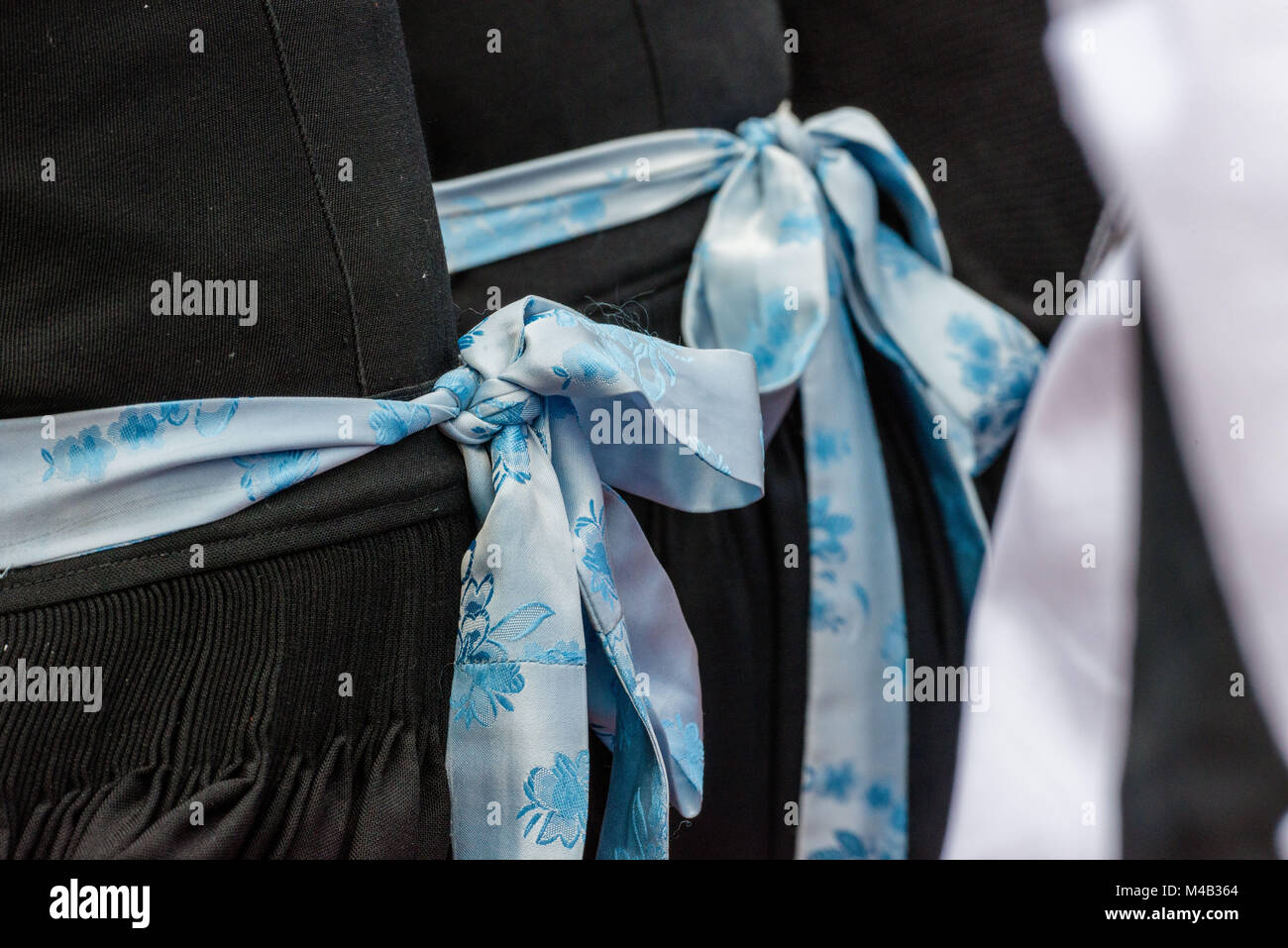 Women,dirndls,aprons,blue loops,detail, Stock Photo