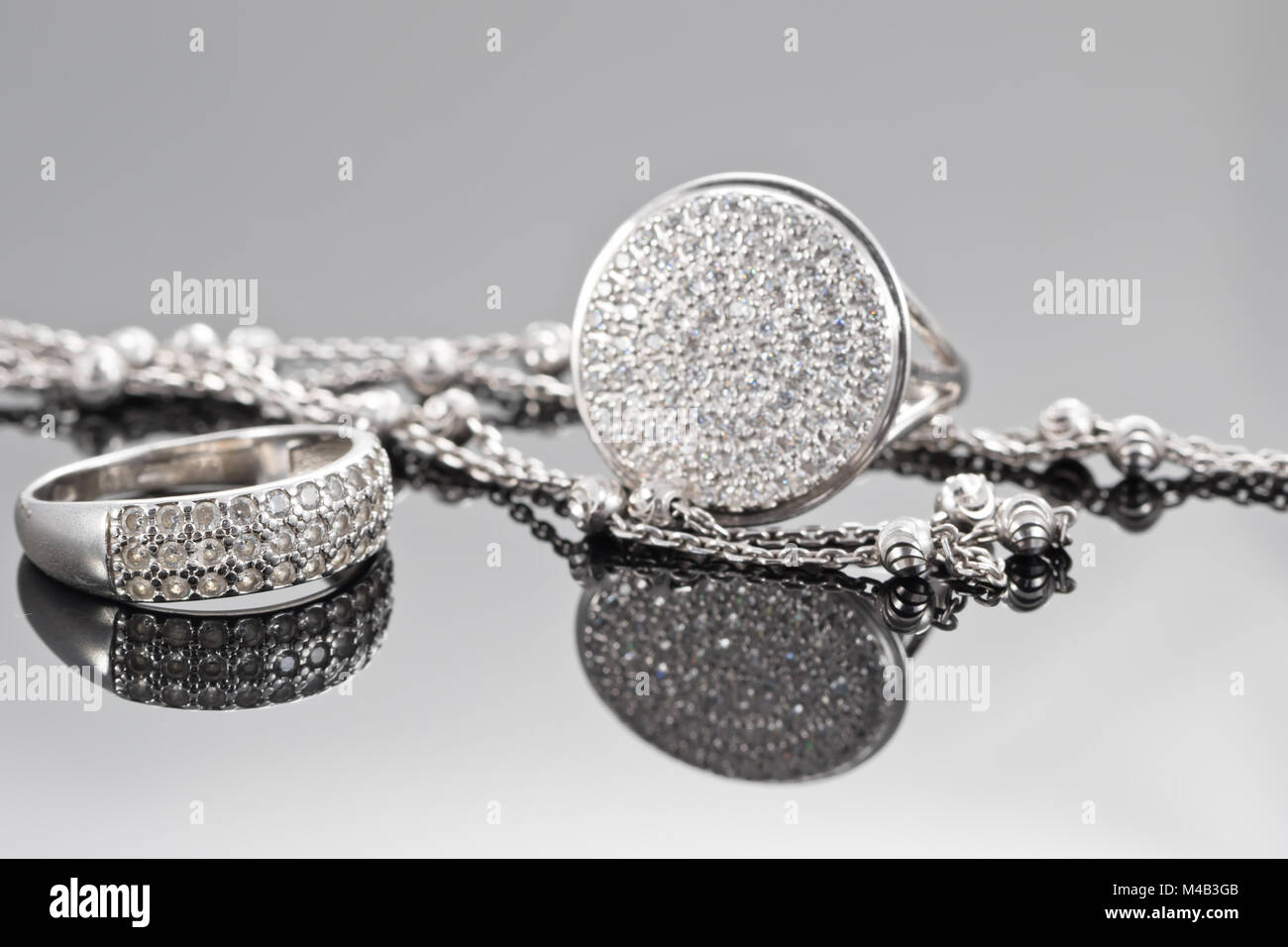 Unusual beautiful silver chain and a silver ring with gems Stock Photo