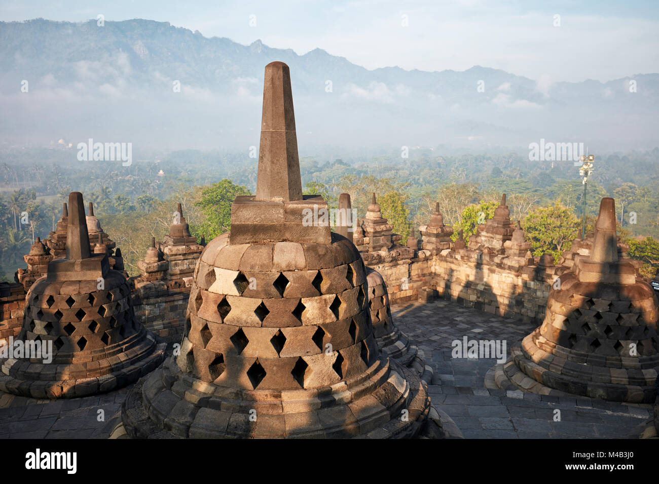 Rhombus holed stupas in Borobudur Buddhist Temple. Magelang Regency, Java, Indonesia. Stock Photo