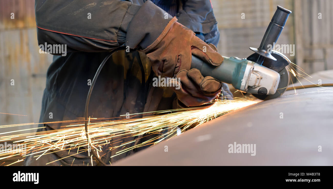 Sparks when machining a weld bead on the pipe Stock Photo