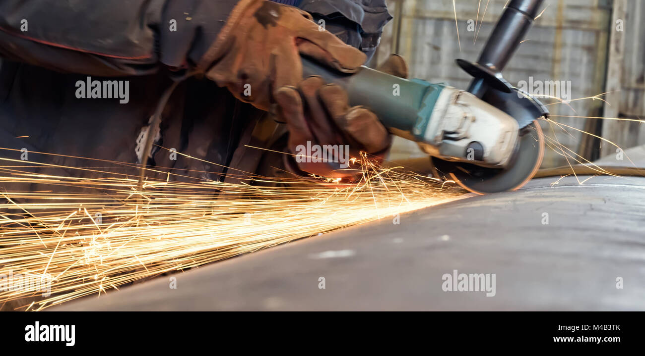 Sparks during machining of the weld Stock Photo
