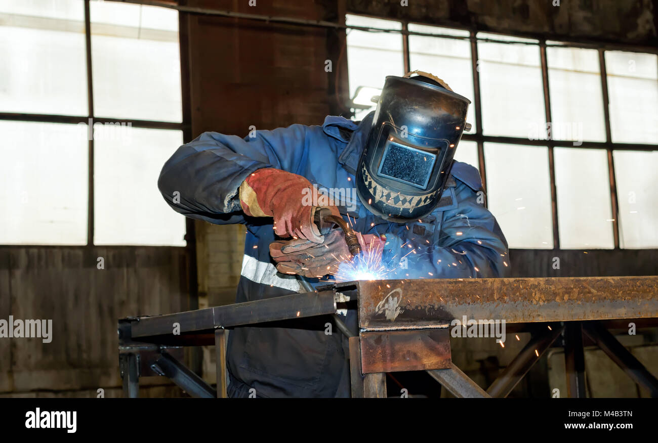 Semi-automatic welding of metal structures in the shop Stock Photo