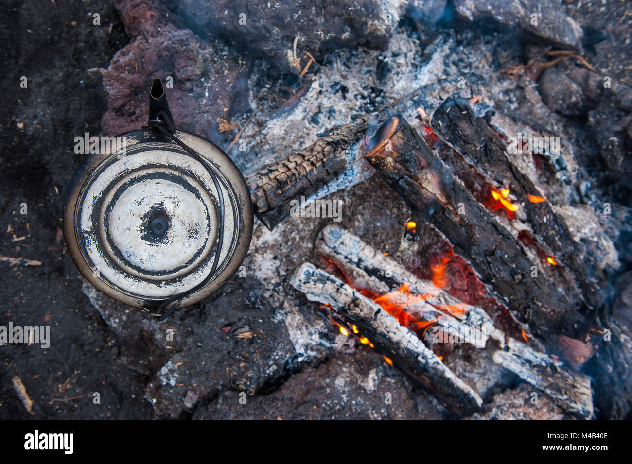 Boiling water pot over an open fire on a campsite on Tolbachik volcano