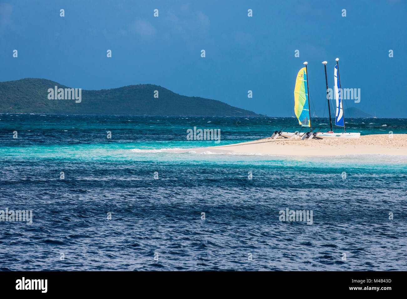 Catamarans on a beautiful white sand beach on Palm island,Grenadines islands,St. Vincent and the Grenadines,Caribbean Stock Photo