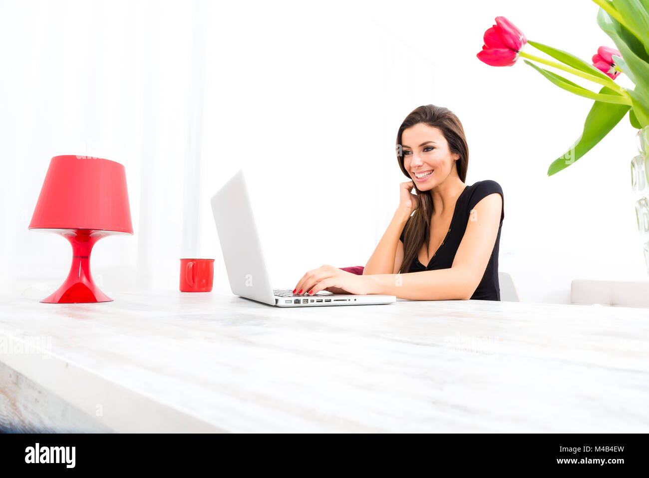 Young beautiful woman using a Laptop at home Stock Photo - Alamy