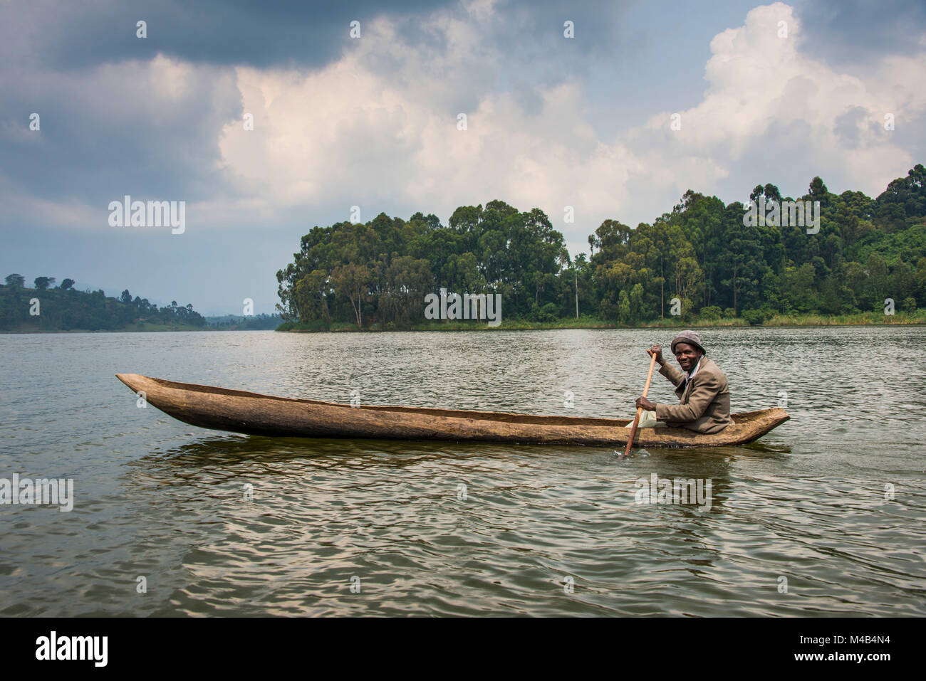 Local in a dugout canoe,Lake Bunyonyi,Uganda,Africa Stock Photo