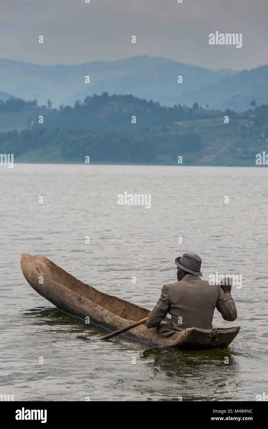 Local in a dugout canoe,Lake Bunyonyi,Uganda,Africa Stock Photo