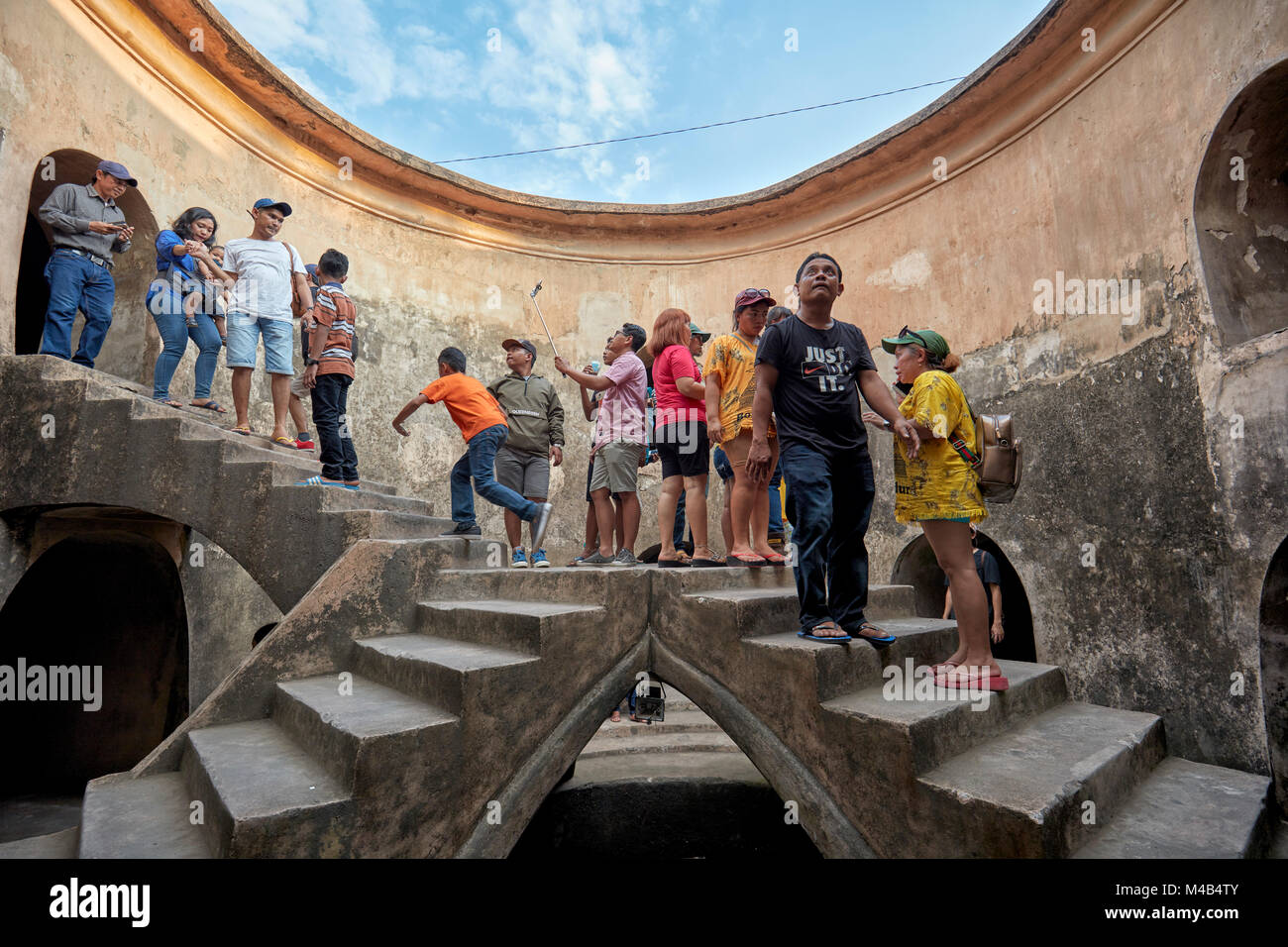People in Gumuling Well (Sumur Gumuling), one-storeyed circular structure, once used as a mosque. Taman Sari Water Castle, Yogyakarta, Java, Indonesia Stock Photo