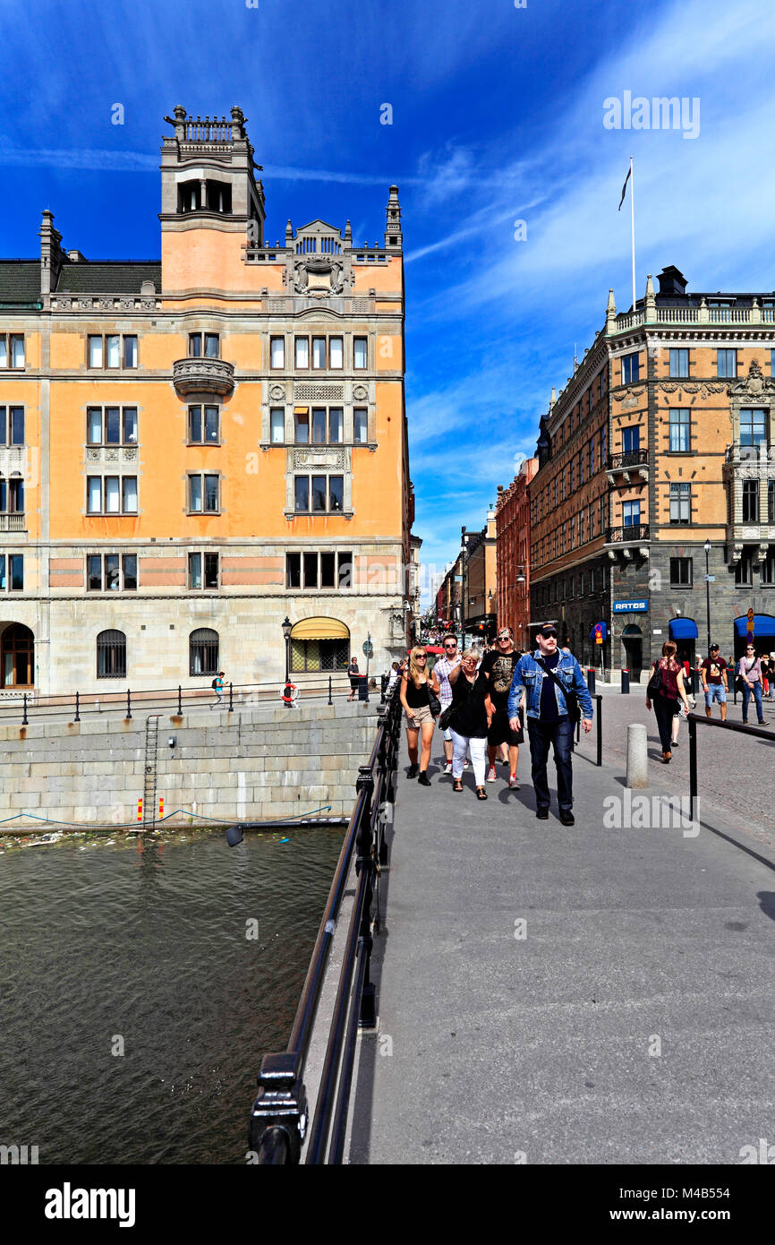 Stockholm / Sweden - 2013/08/01: Norrmalm district view from Old town quarter Gamla Stan - Drottninggatan street and Riksbron bridge Stock Photo