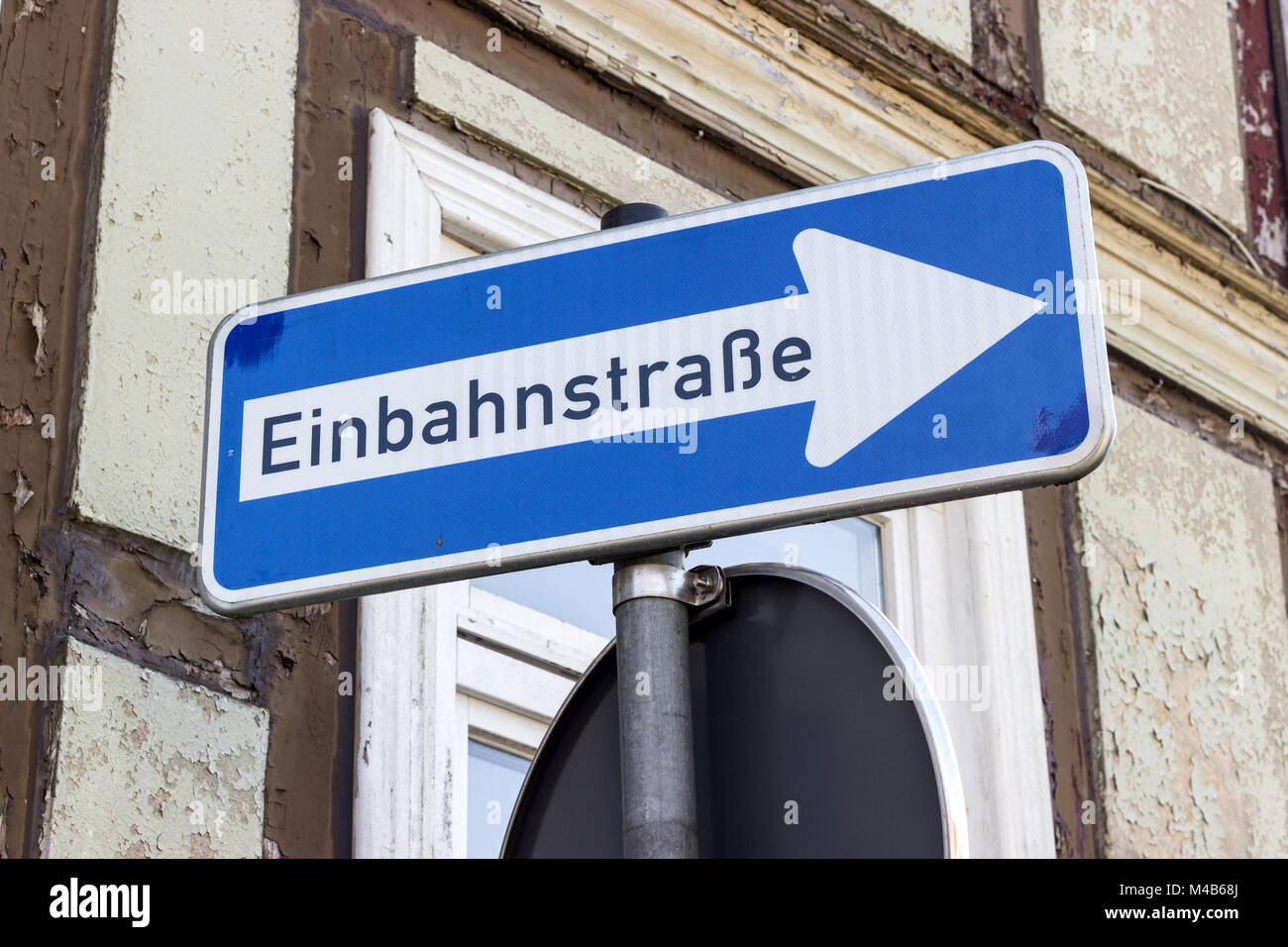 Road sign with german text: one-way street in front of a half-timbered house Stock Photo