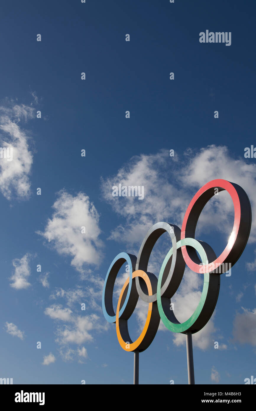 The symbol of the Olympic Games, five interlocking rings, colored blue,  yellow, black, green, and red on a white field Stock Photo - Alamy