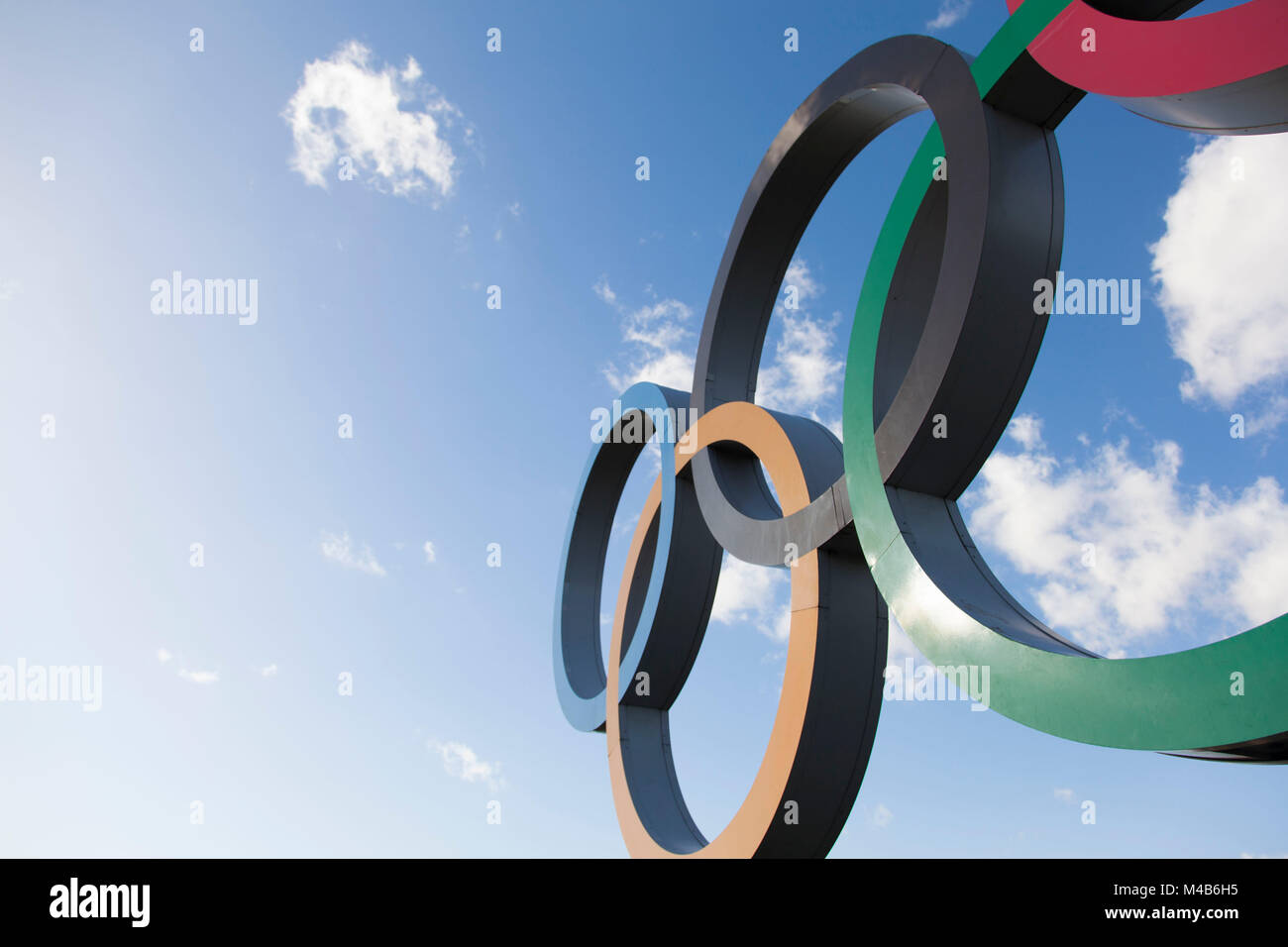 LONDON, UK - February 15th 2018: The Olympic symbol, made up of five interconnected coloured rings, under a blue sky Stock Photo