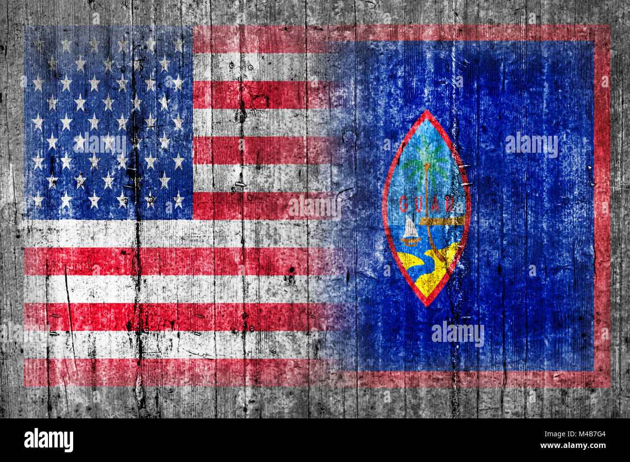 USA and Guam flag on concrete wall Stock Photo