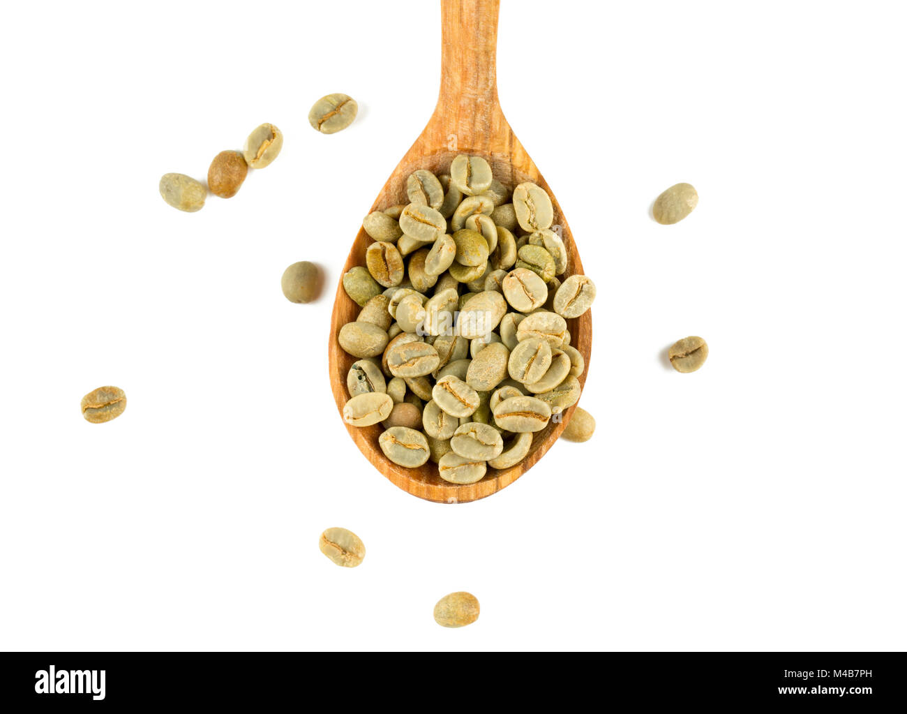 green coffee beans in a wooden spoon Stock Photo