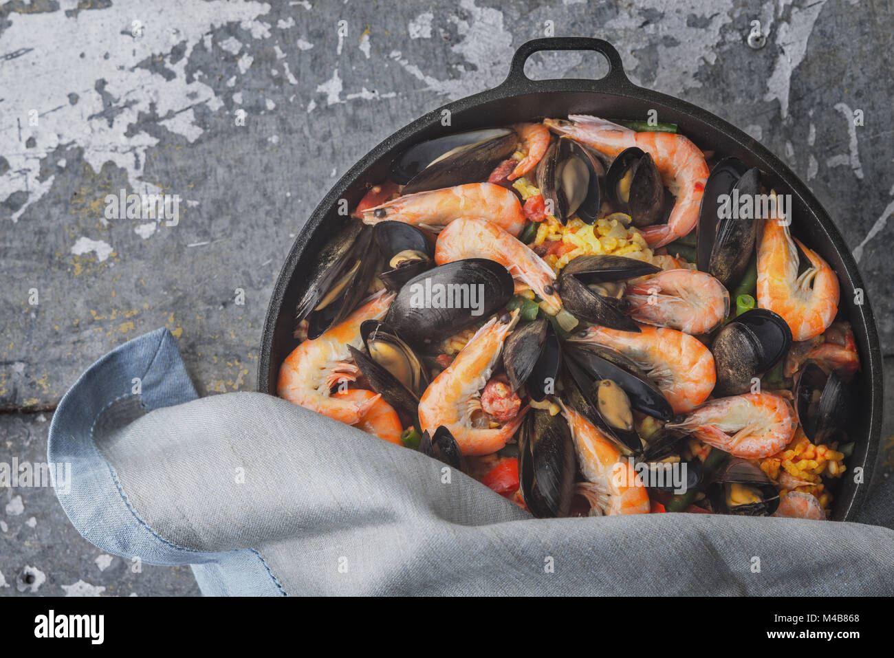 Paella in the pan on the metal background top view Stock Photo