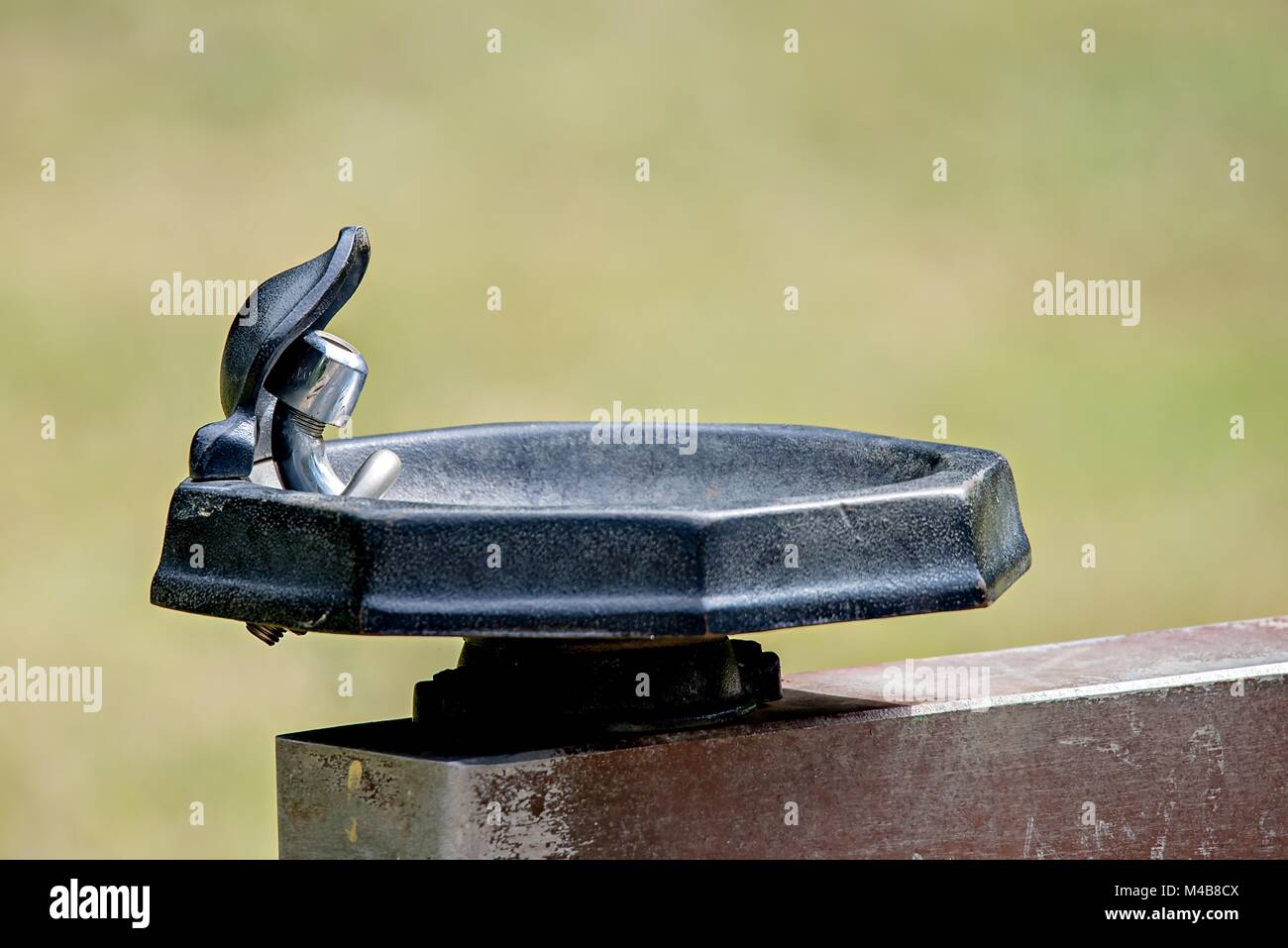 Closeup of a public drinking water tap in a park Stock Photo