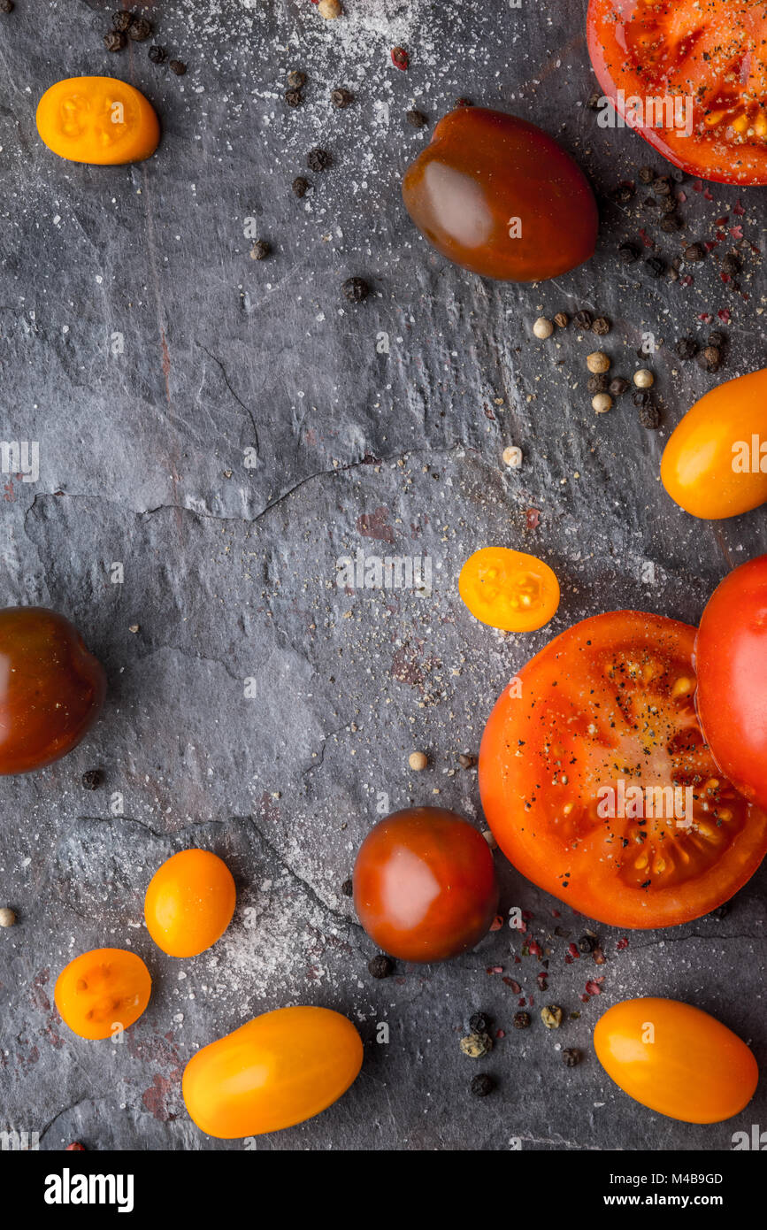 Tomatoes mix  with seasoning on the stone table Stock Photo