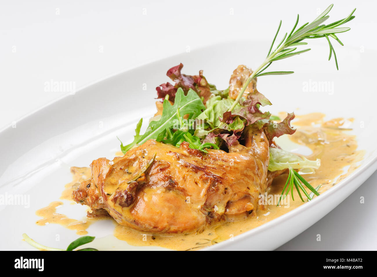 Baked and stewed rabbit legs Stock Photo - Alamy