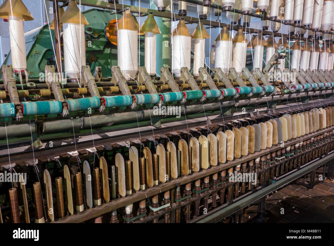 Spindles on ring spinning frame, machine for spinning fibres to make yarn in cotton mill / spinning-mill Stock Photo