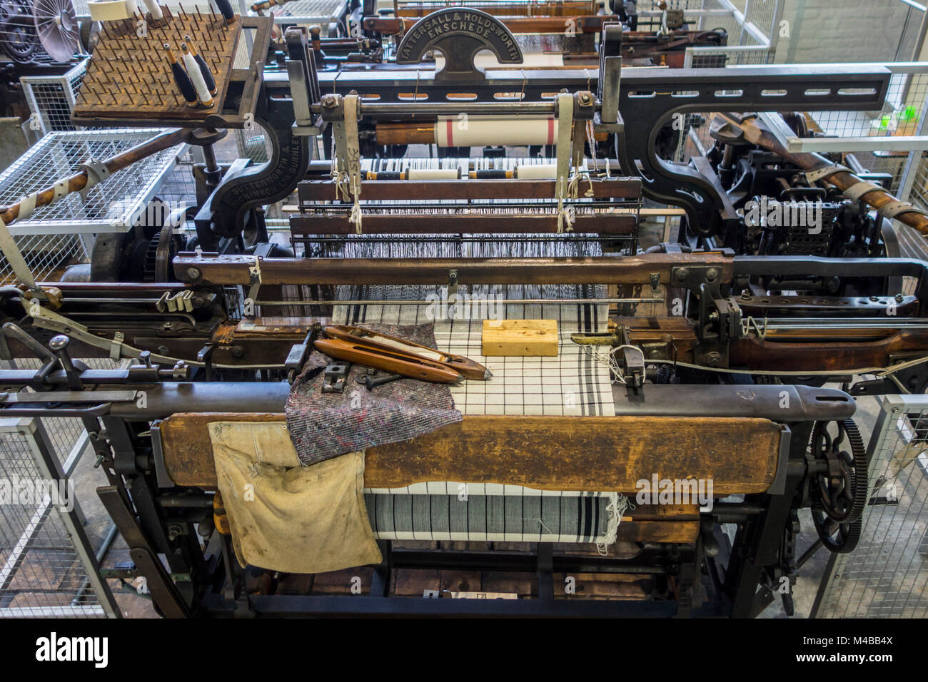 Mechanical flying shuttle loom / Tattersall & Holdsworth shuttle weaving machine in cotton mill / spinning-mill Stock Photo