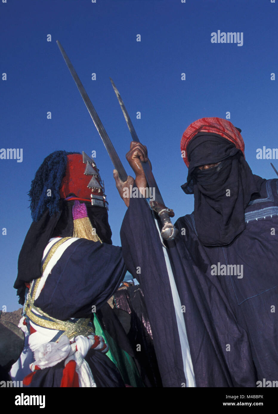 Algeria. Djanet. Sahara desert. Annual festival from people of Tuareg tribe called SBIBA. Men dancing. Stock Photo