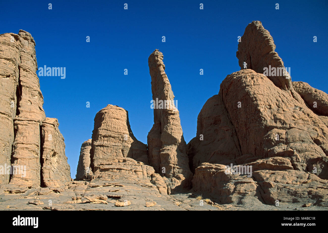 Algeria. Near Djanet. National Park Tassili n'Ajjer. Tassili Plateau. UNESCO World Heritage site. Sahara desert. On top Man of Tuareg tribe. Nomad. Stock Photo