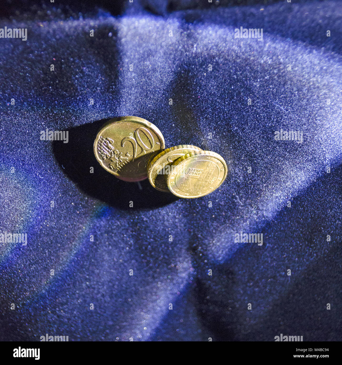 Eurocent coins on blue velvet Stock Photo